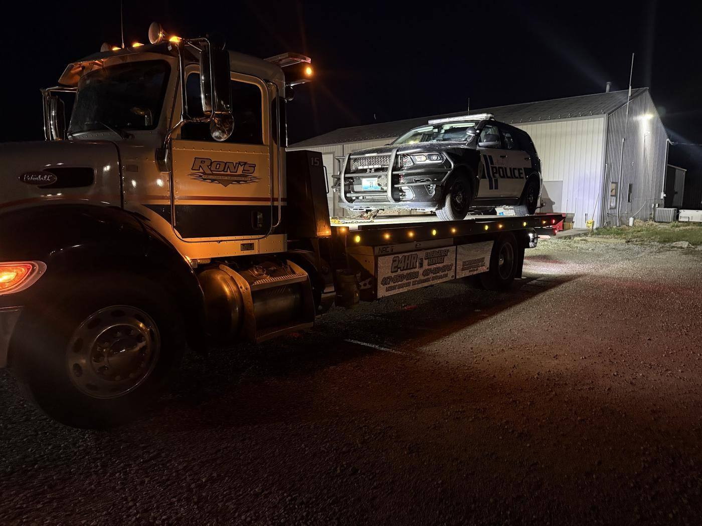 Ron's Peterbilt flatbed carrying a Neosho Police SUV at night